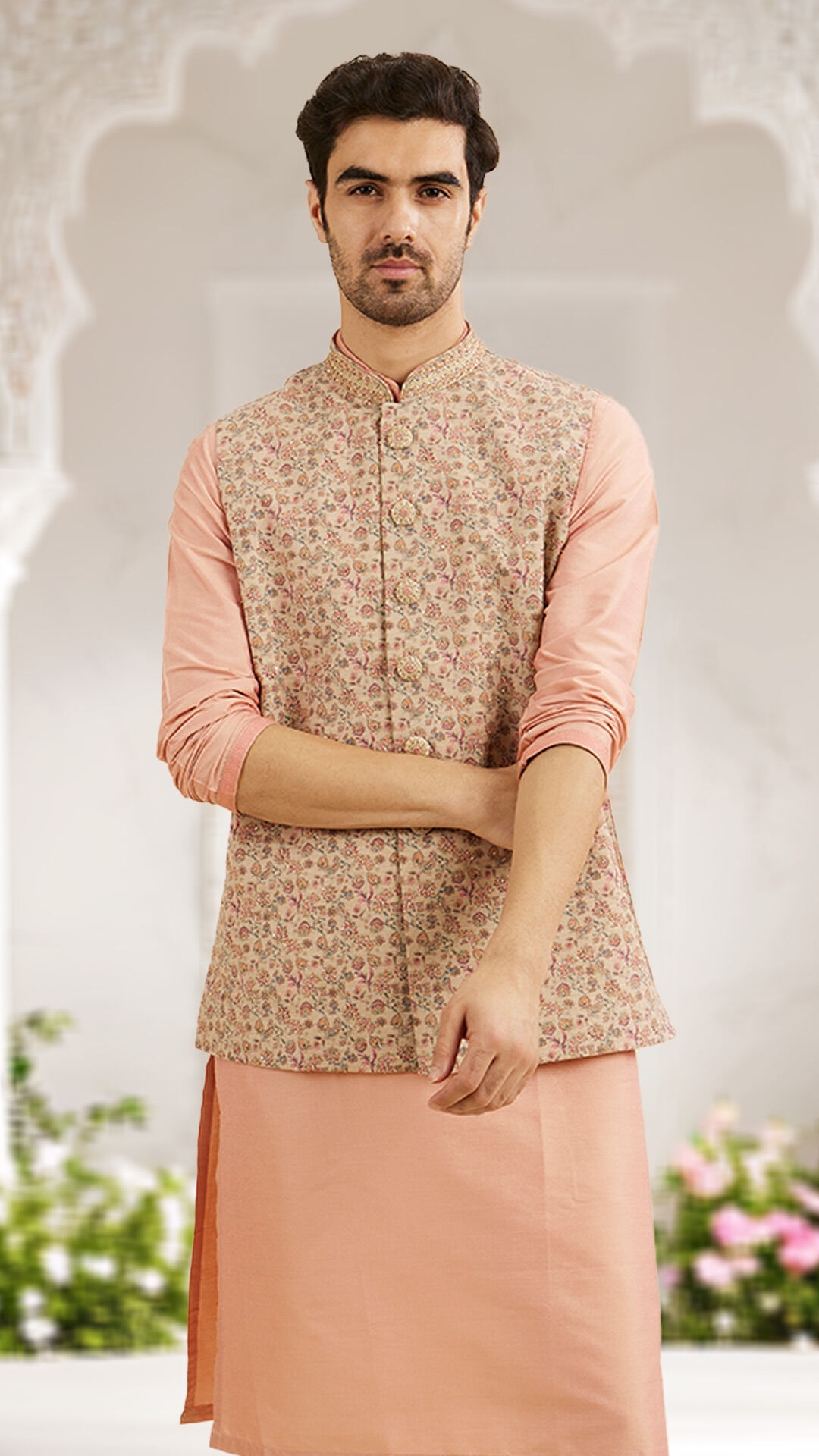 A man wearing light pink beige printed nehru jacket for destination wedding